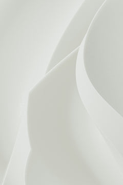 Abstract shapes of white paper gently curving.