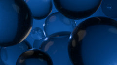 Numerous blue translucent spheres floating against a blue background.